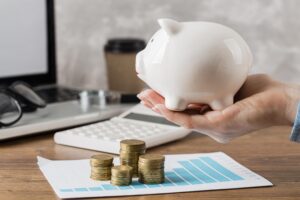 main-tenant-la-tirelire-avec-courbe-de-croissance-et-pieces-de-monnaie